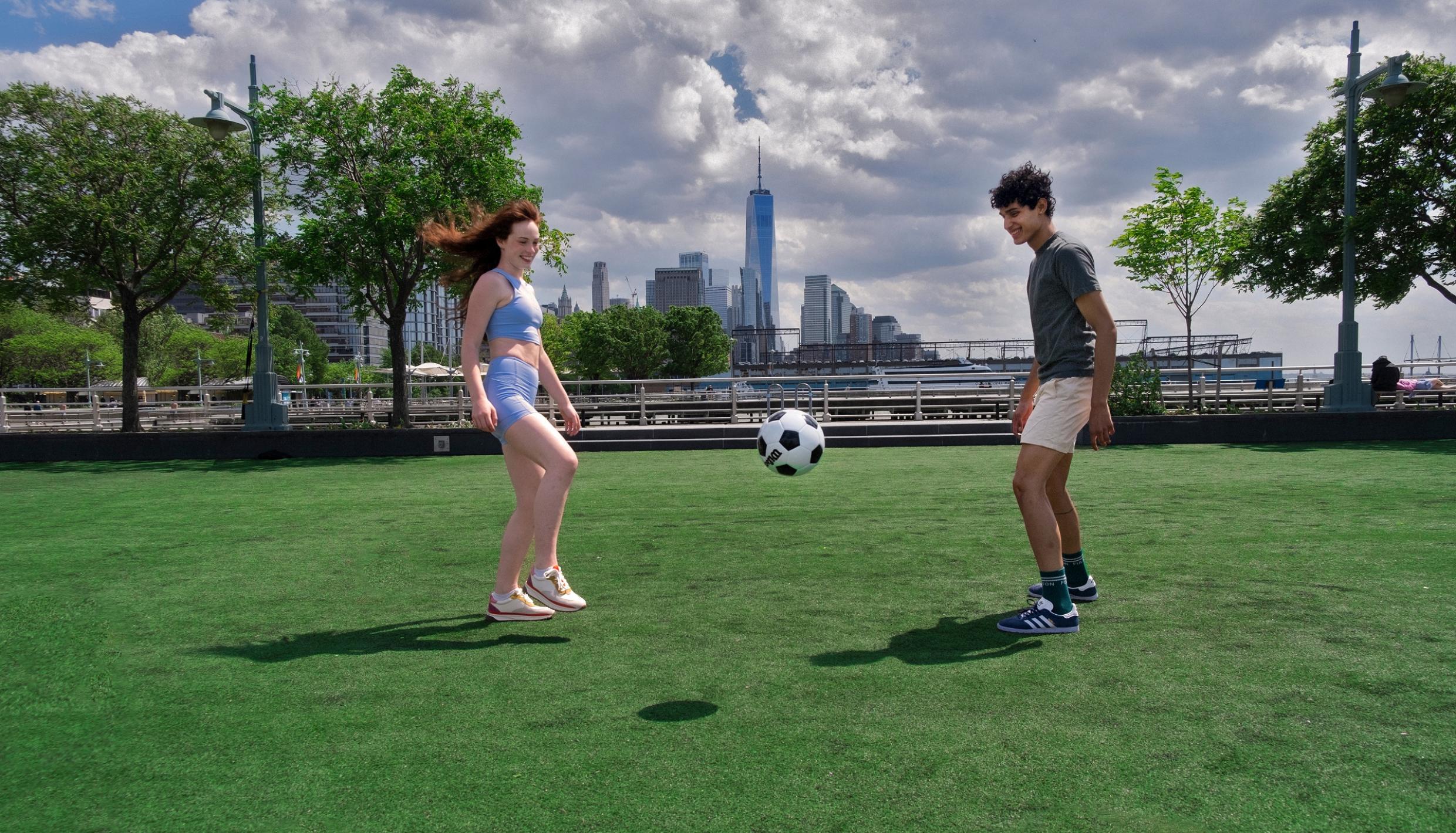 Two people playing soccer