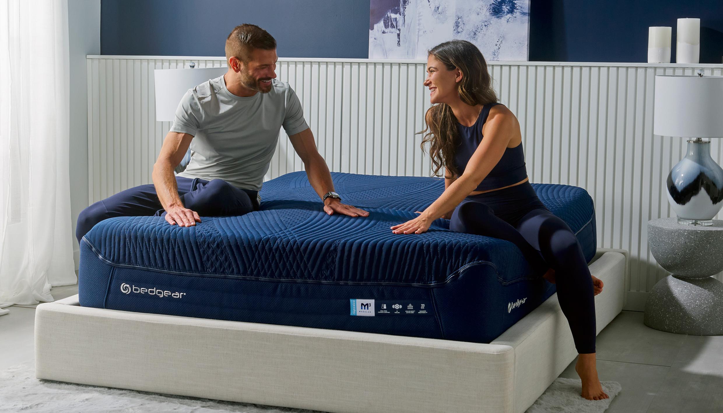 Man and woman sitting on bed