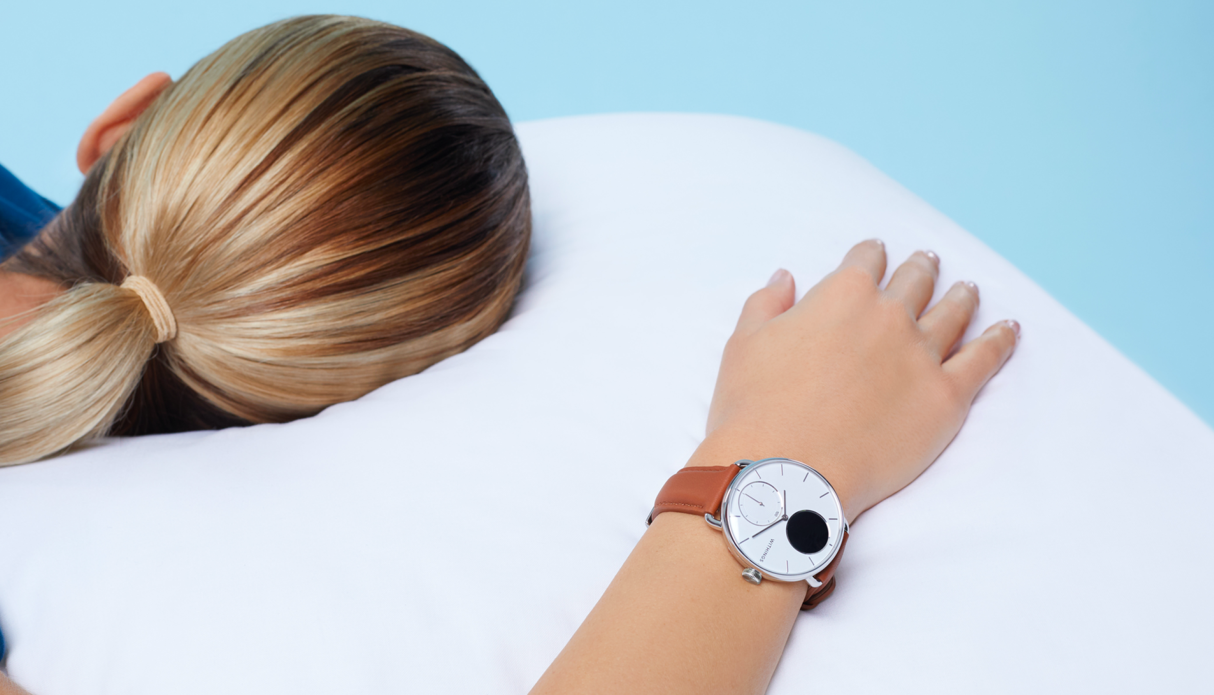 Woman sleeping while wearing smartwatch
