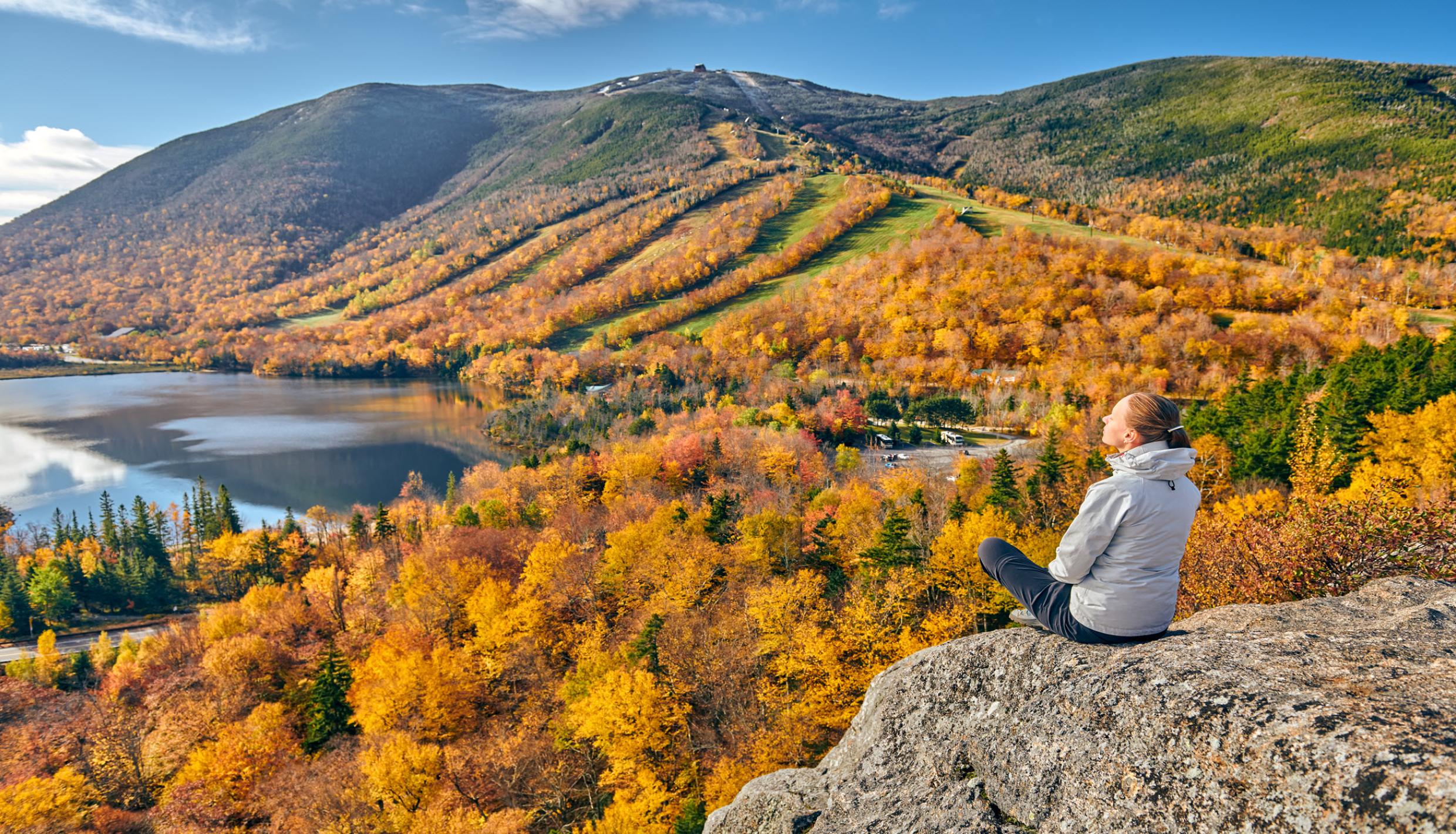 woman sitting on rock
