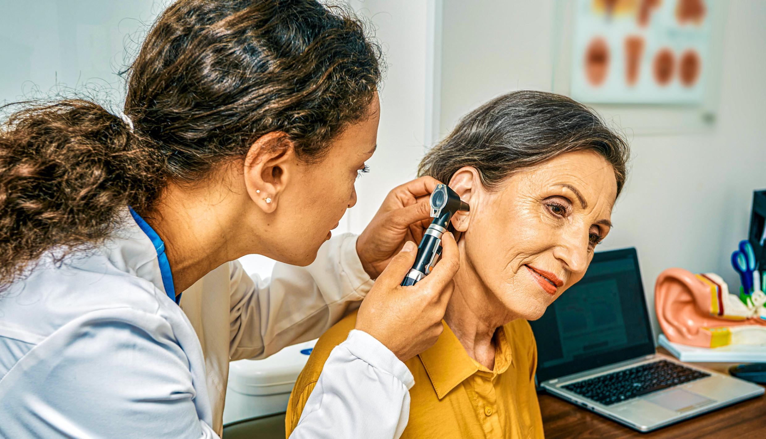 doctor looking at a patients ear