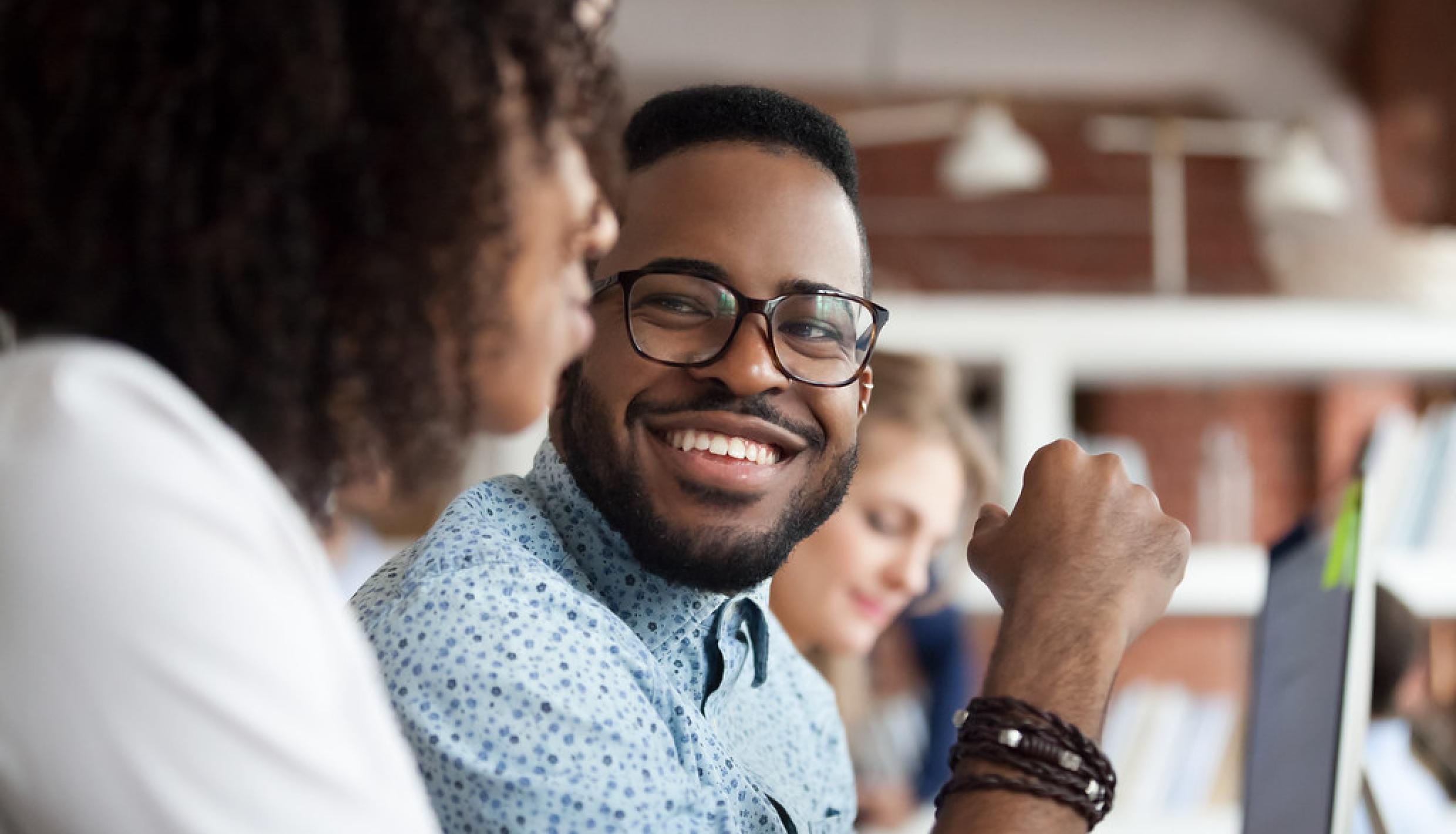 Man with glasses smiling