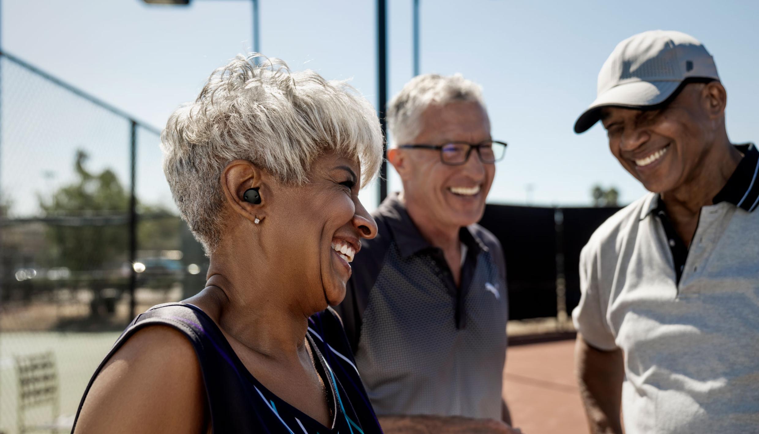 Three people at tennis court