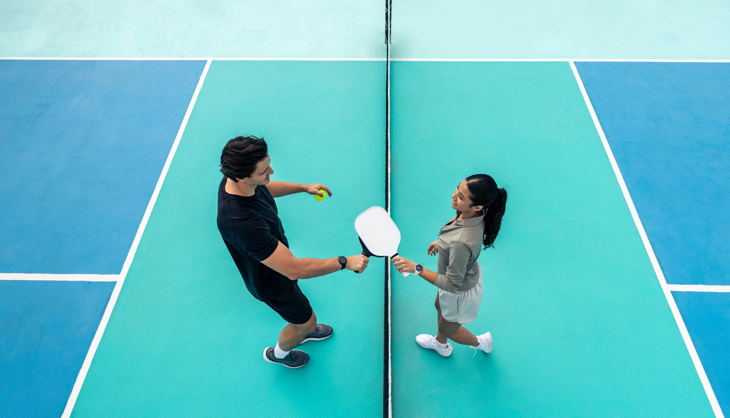 Man and woman on pickleball court
