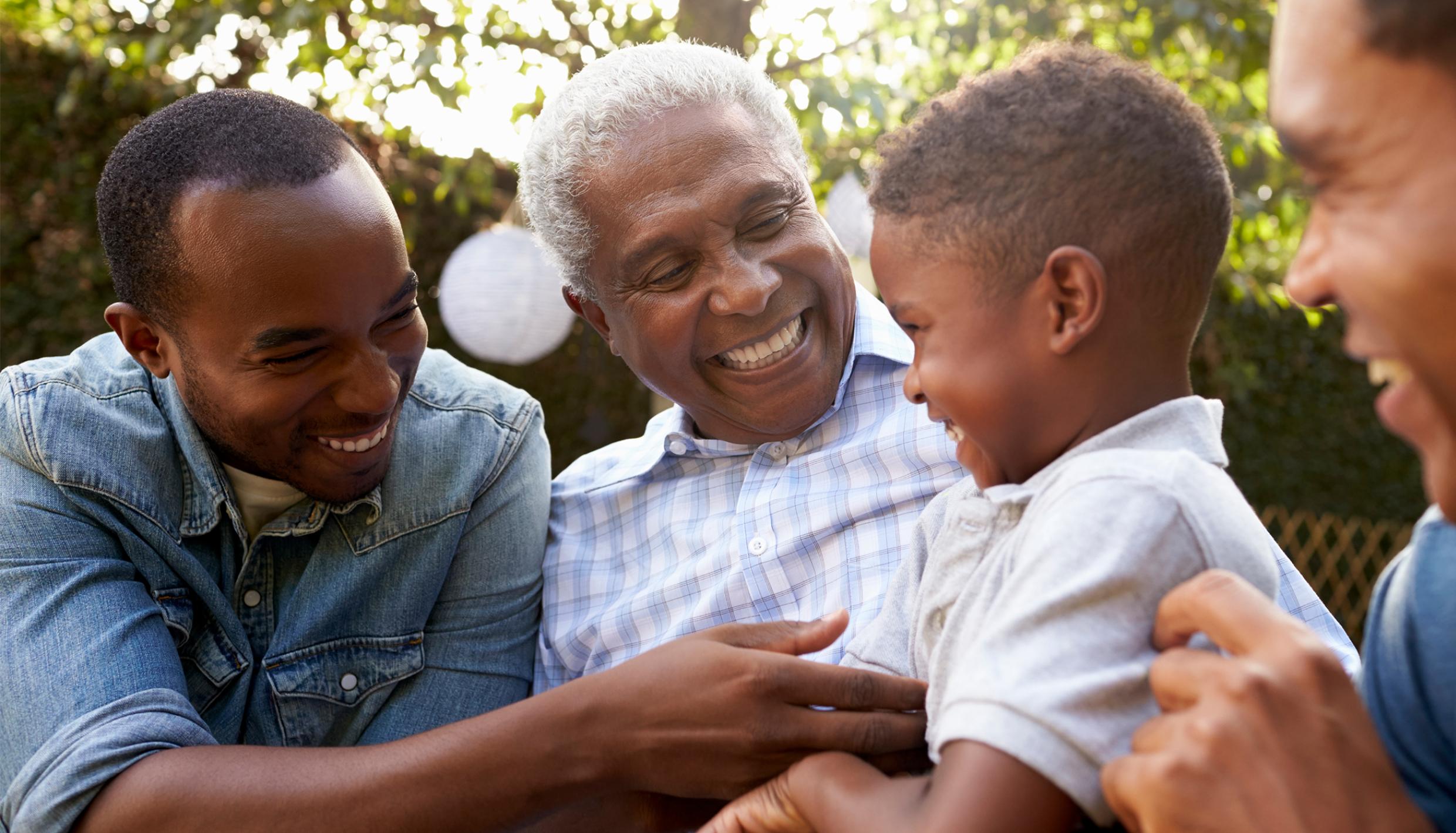 Three men talking to a little boy