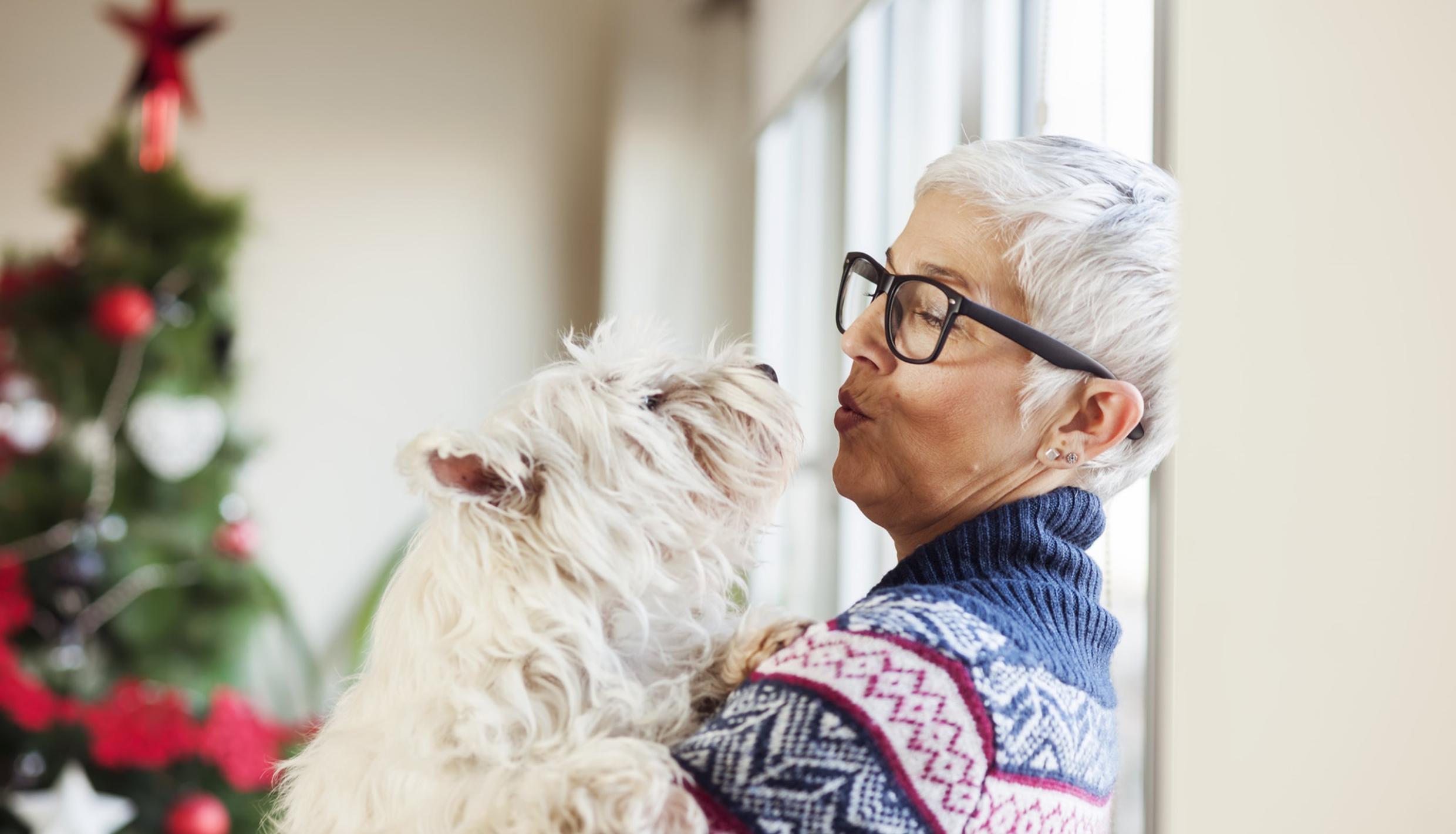 Woman kissing dog