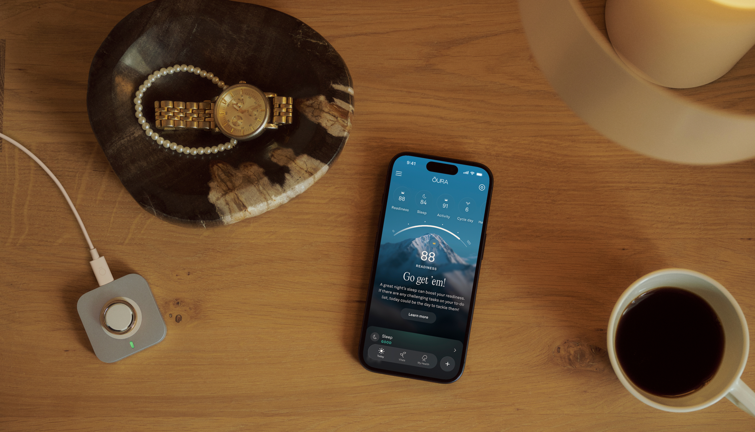 Phone and cup of coffee on table