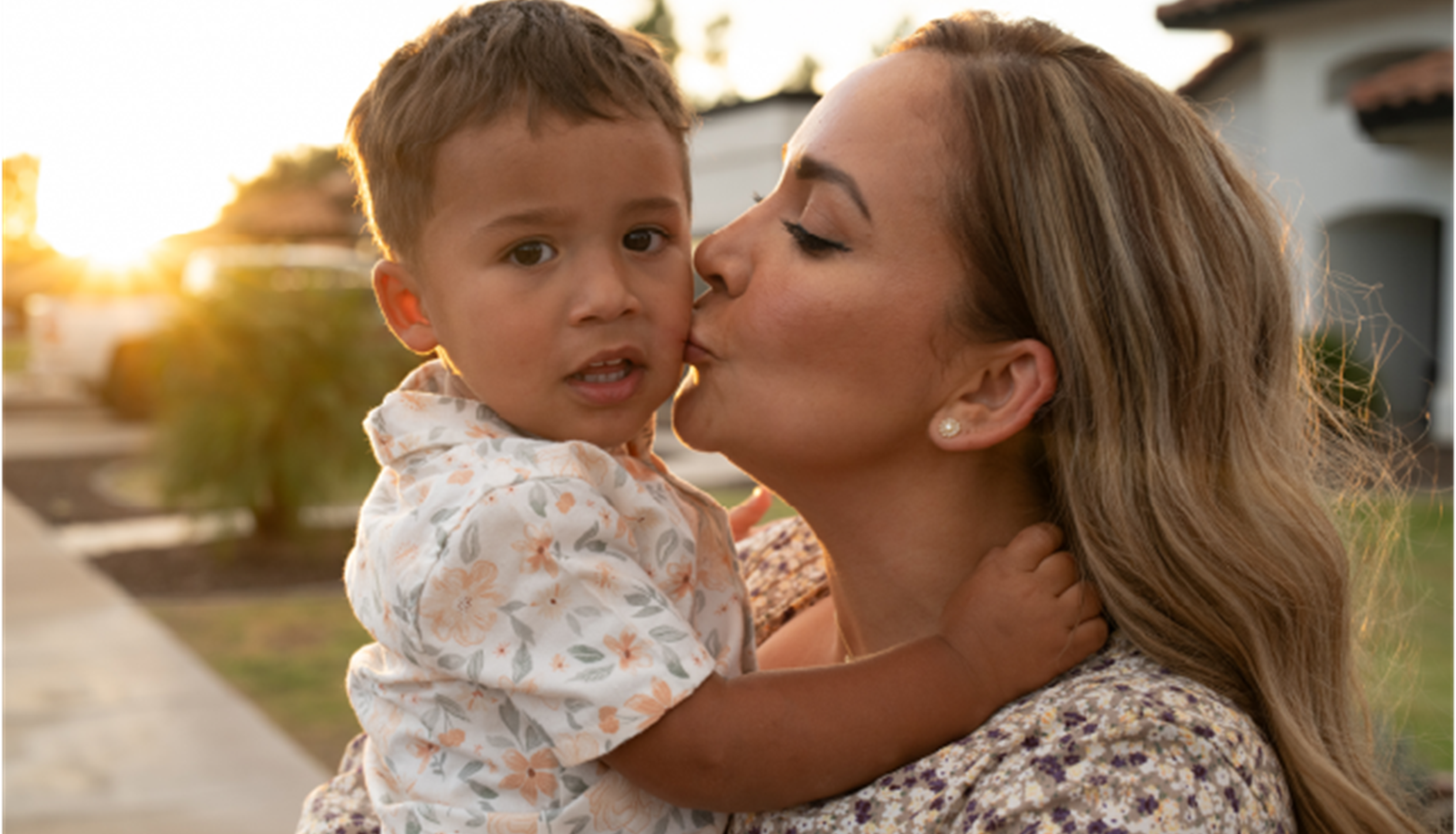 Mom kissing son