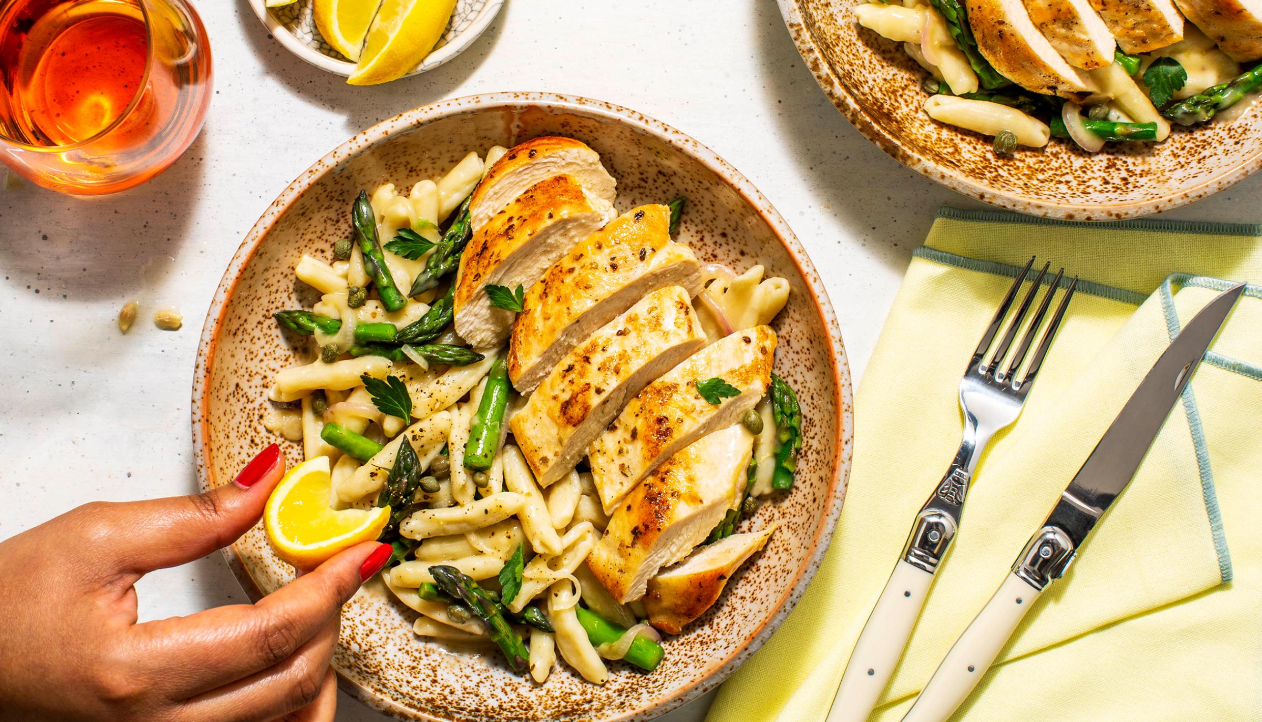 Woman squeezing lemon on chicken salad