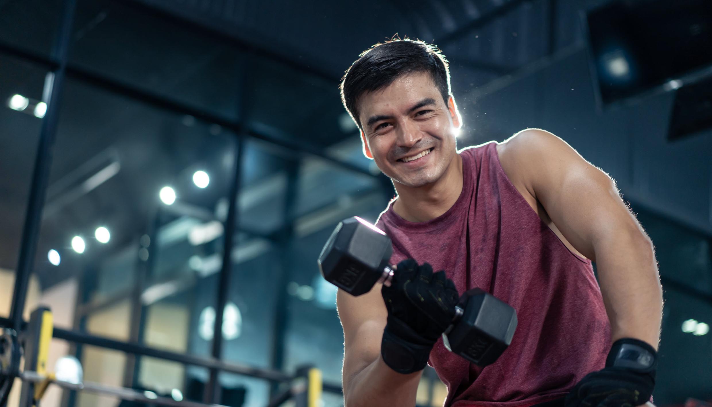 Man with dumbbells and gloves