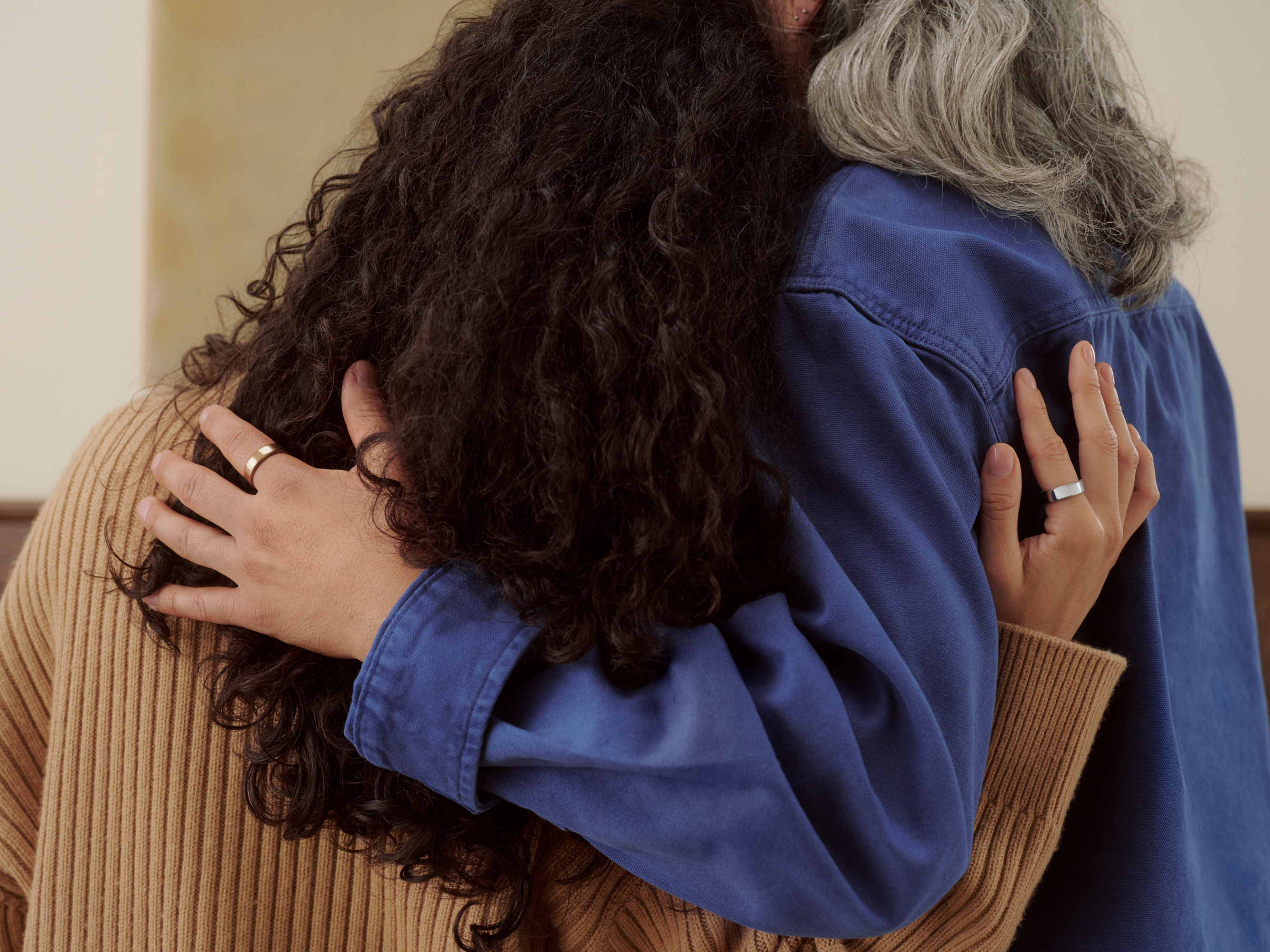 Two women embracing while wearing rings