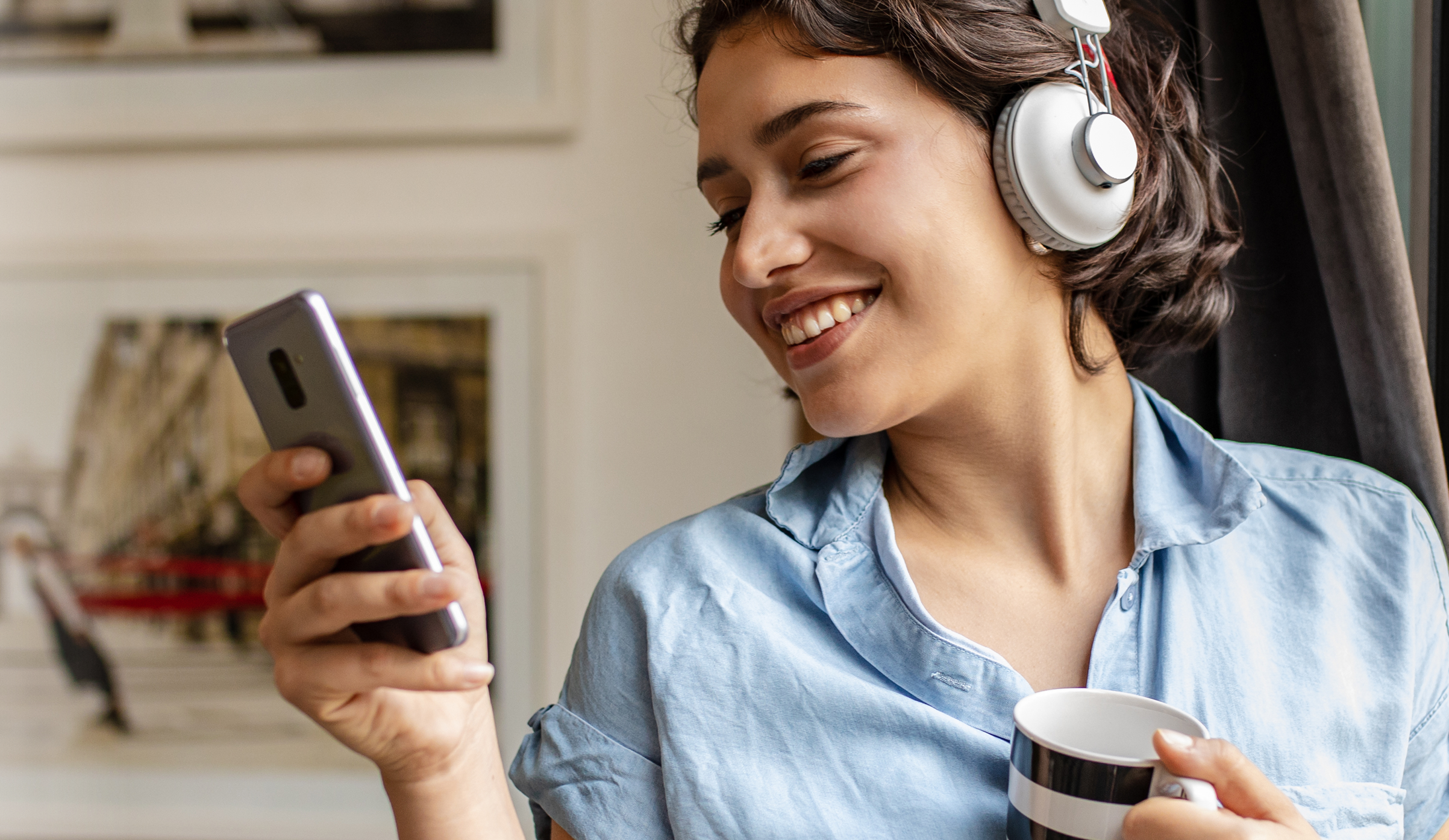 Woman with headphones on her phone
