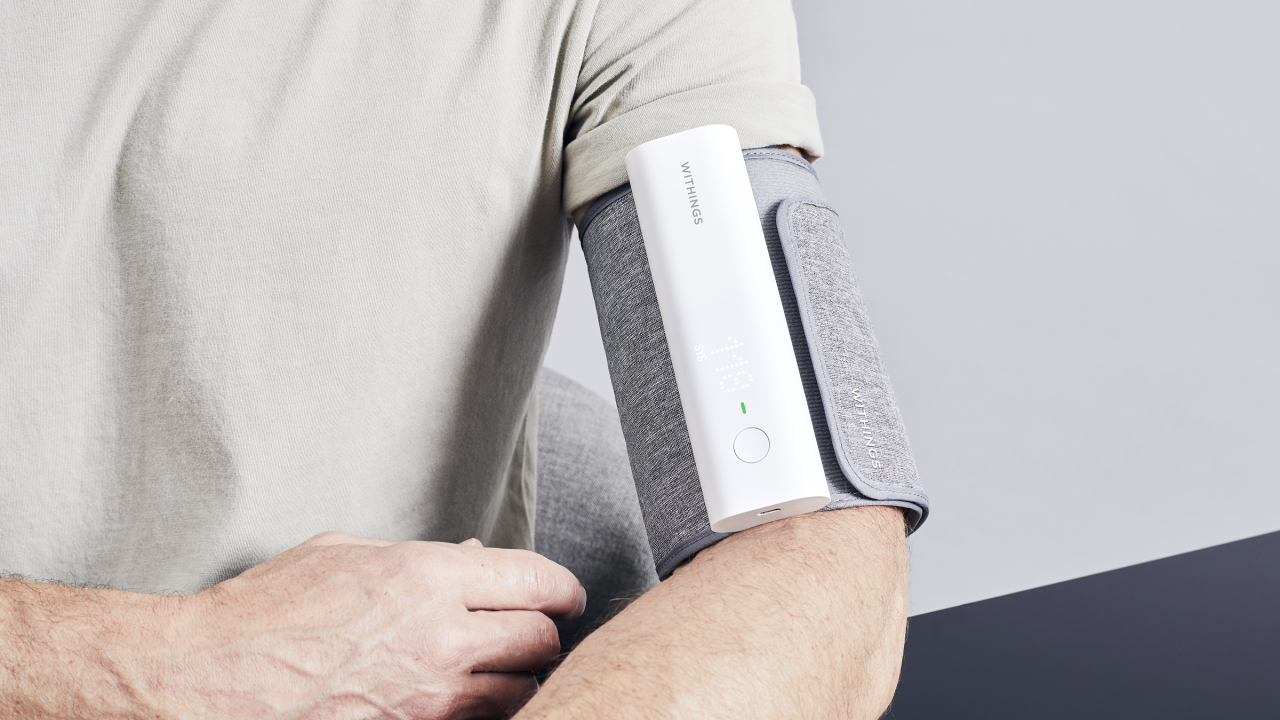 Man using blood pressure monitor