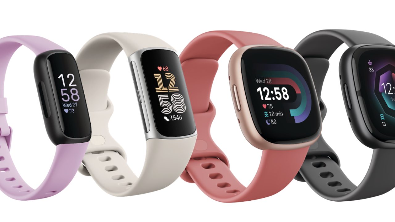 four Fitbit devices lined up together