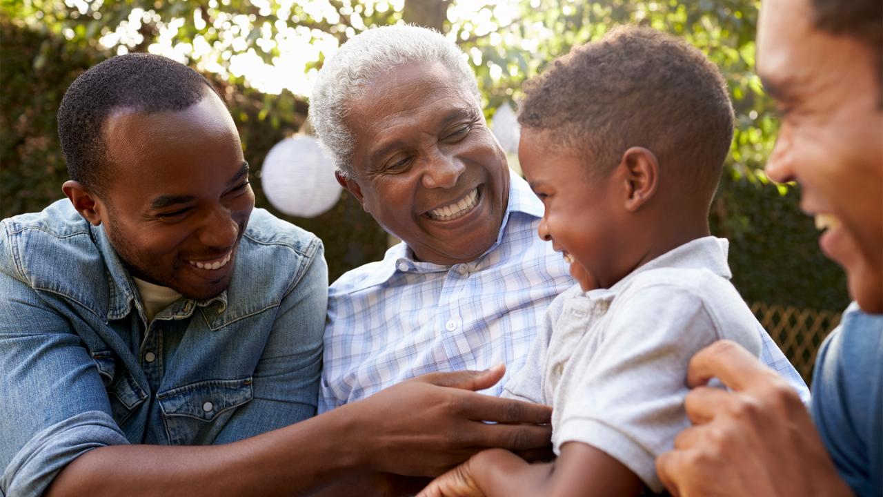 Three men talking to a little boy