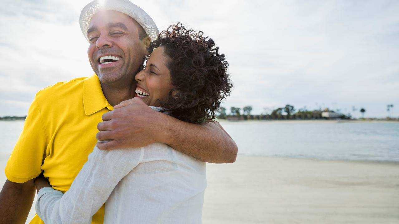 man and woman embracing on vacation