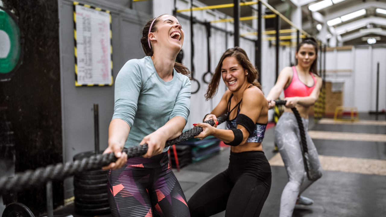Three women pulling on rope
