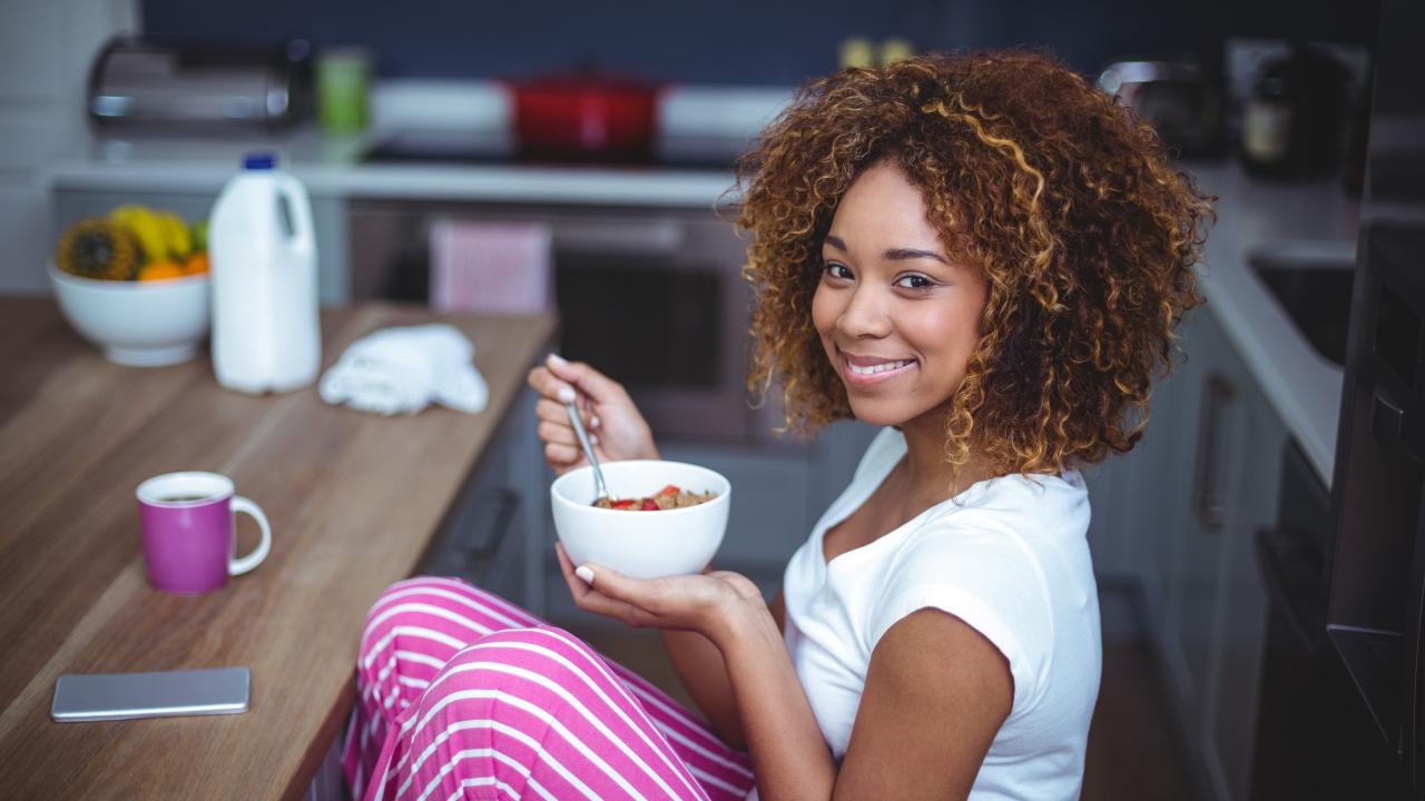 Woman at table eating cereal