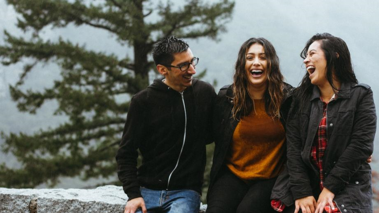 People near tree smiling