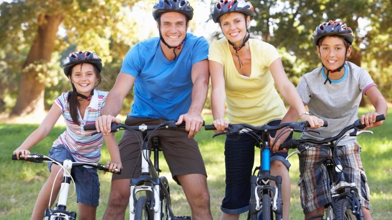 Family on bikes smiling