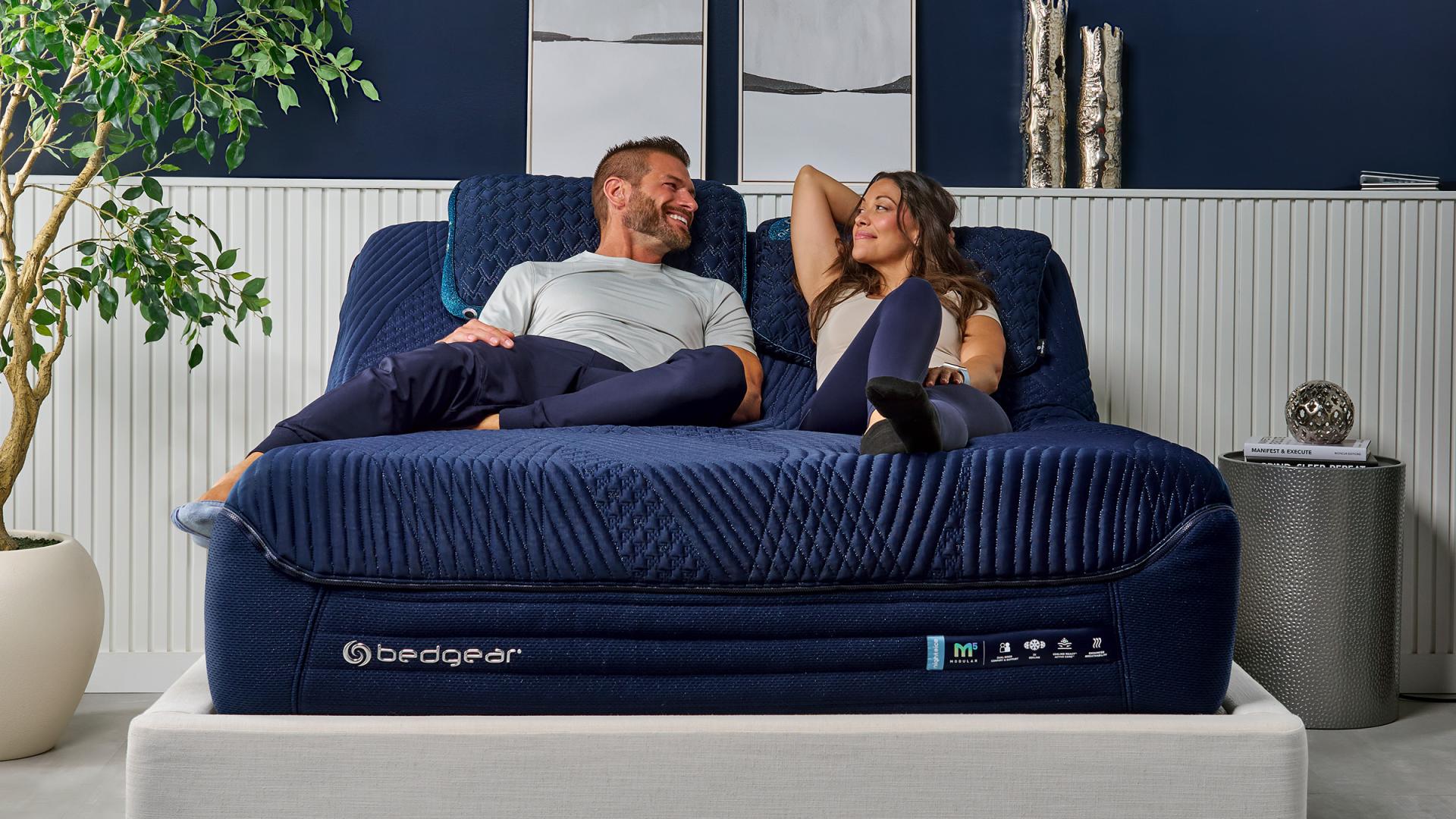 Man and woman sitting on bed