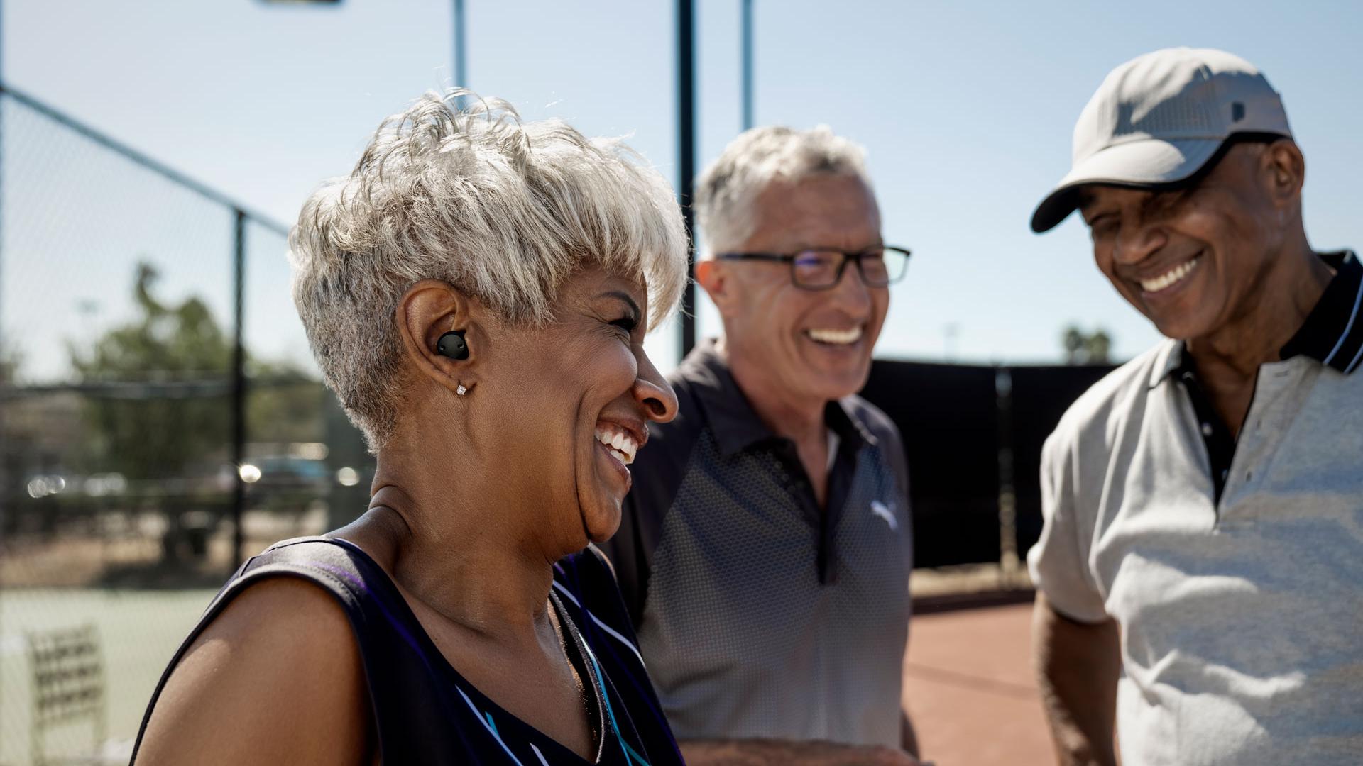Three people at tennis court