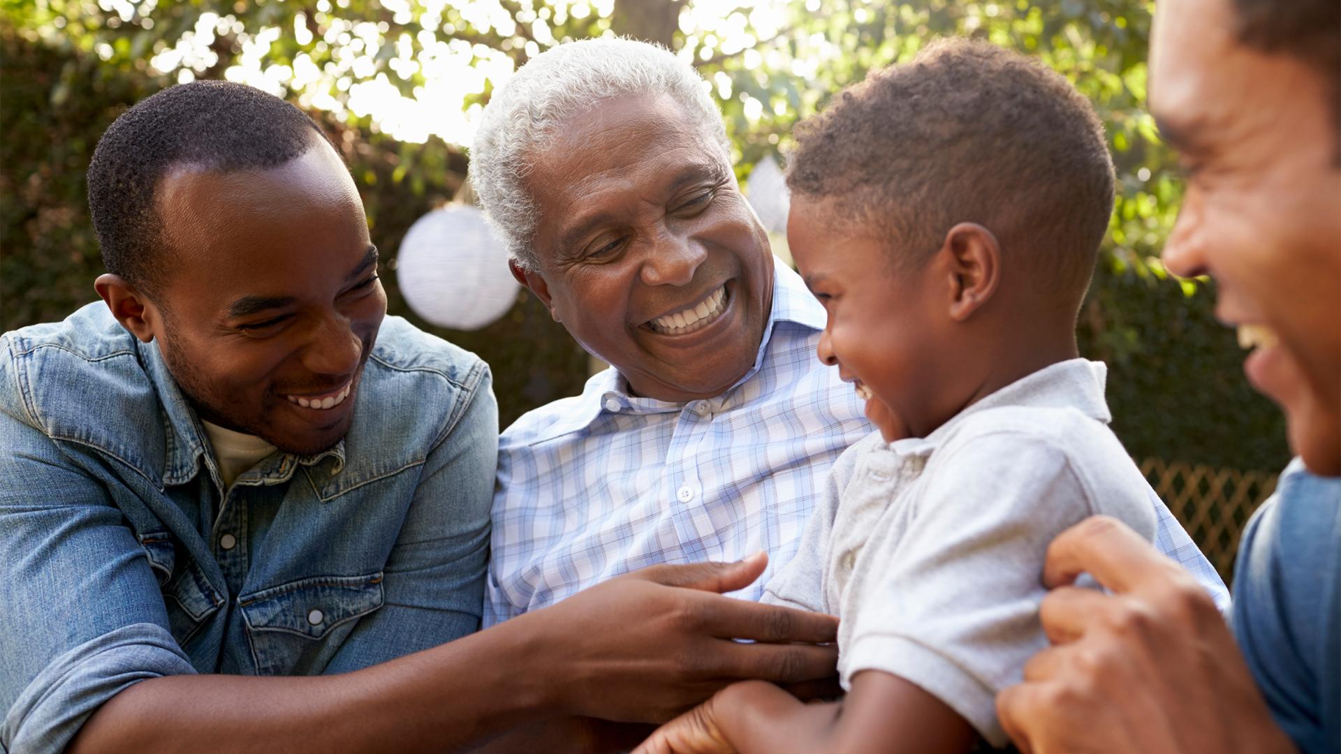 Three men talking to a little boy