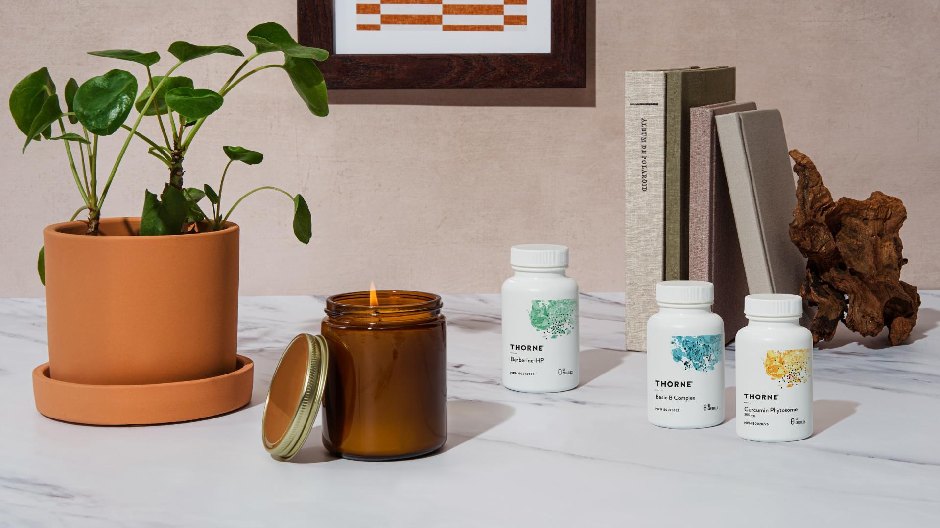 Plant, candle and vitamins on  a table