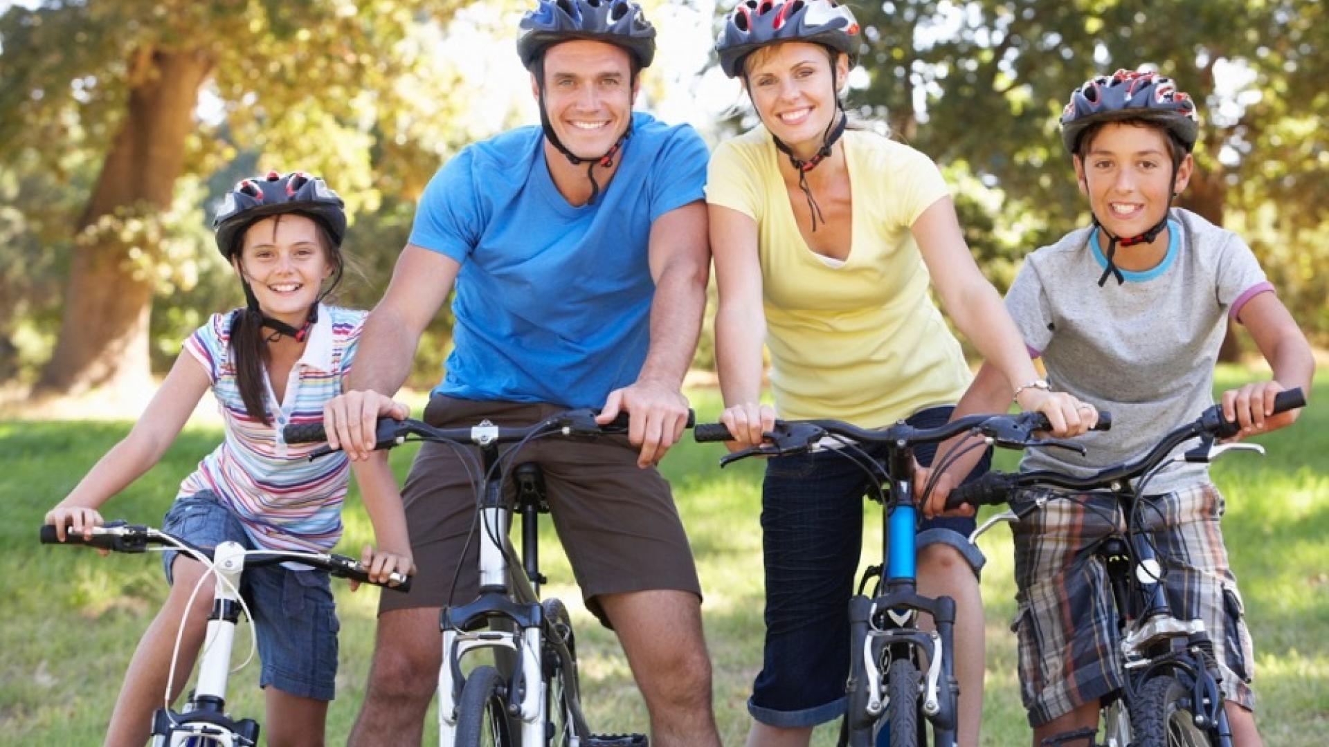 Family on bikes smiling