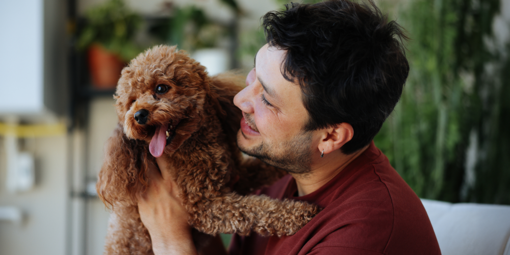 man holding a puppy