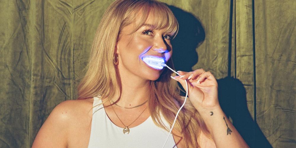 Woman whitening her teeth