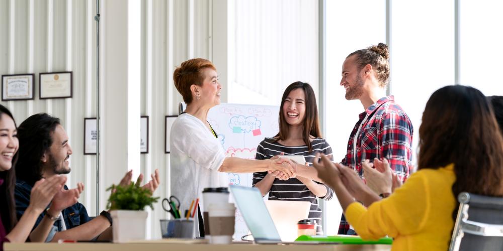 group of coworkers meeting around a table
