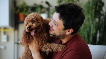 man holding a puppy