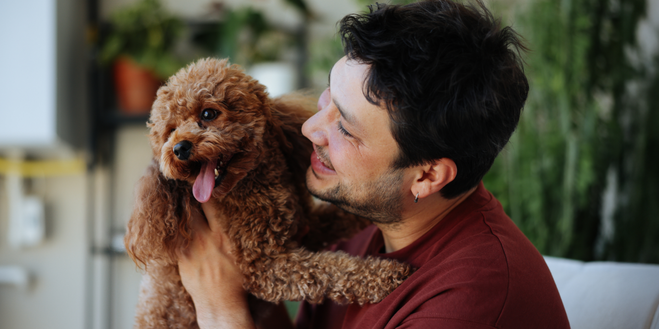 man holding a puppy