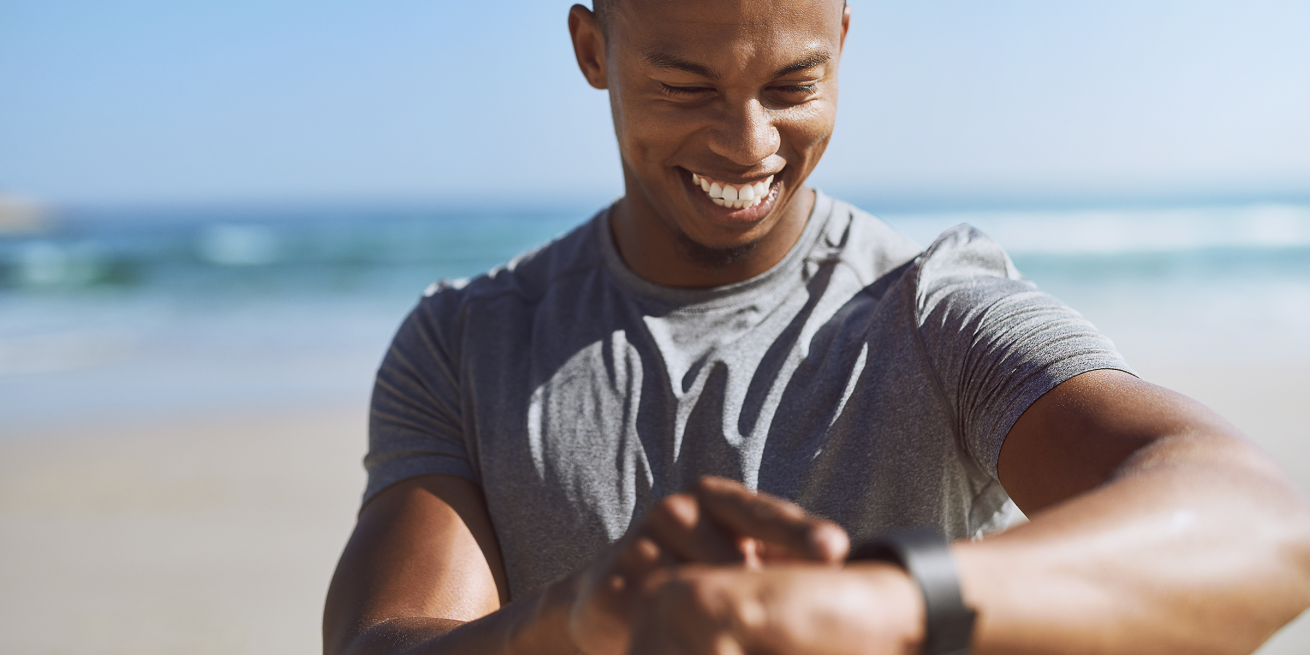 man looking at wearable device