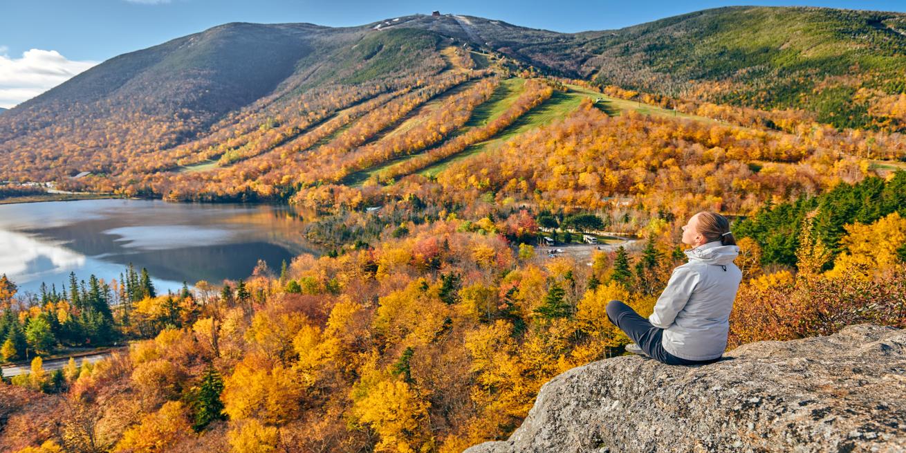 woman sitting on rock