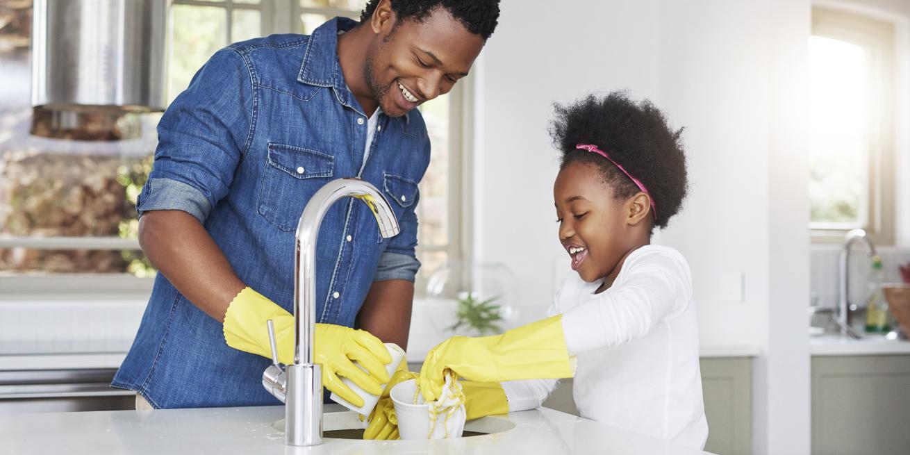 Father daughter washing dishes together