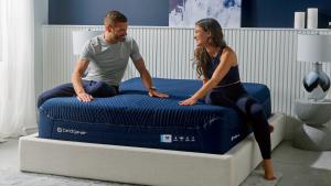 Man and woman sitting on bed