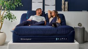 Man and woman sitting on bed