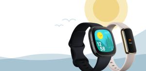 two fitbit watches with a sun in background
