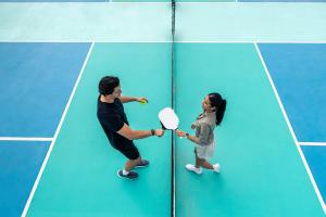 Man and woman on pickleball court