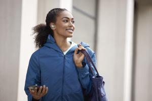 Woman using earbuds 