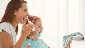 Mom and daughter brushing teeth