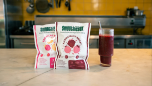 Smoothiebox packets and smoothie on counter