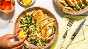 Woman squeezing lemon on chicken salad
