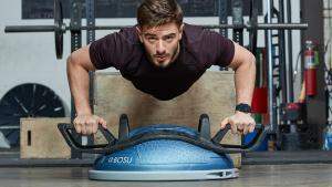man working out with a bosu