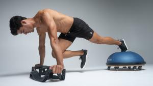 man working out with a bosu